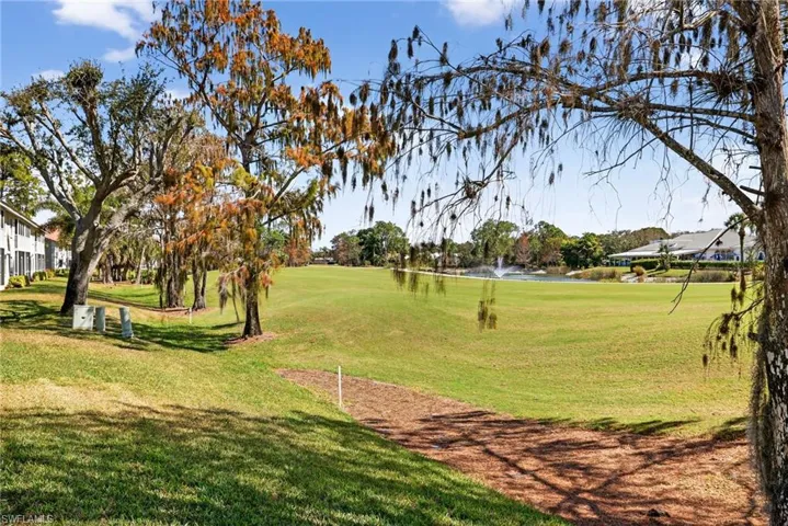 View of property's community with view of golf course and a water view