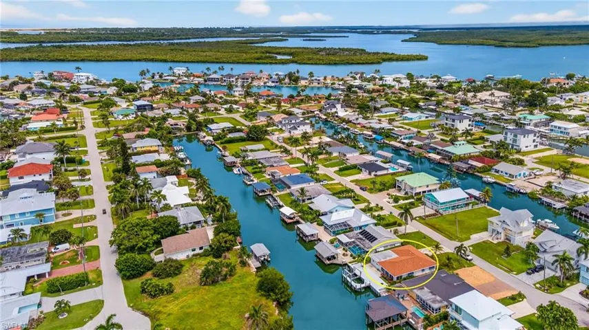 Aerial perspective of suburban area featuring a large body of water