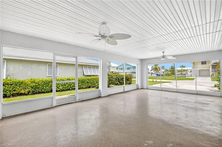 Unfurnished sunroom with a ceiling fan