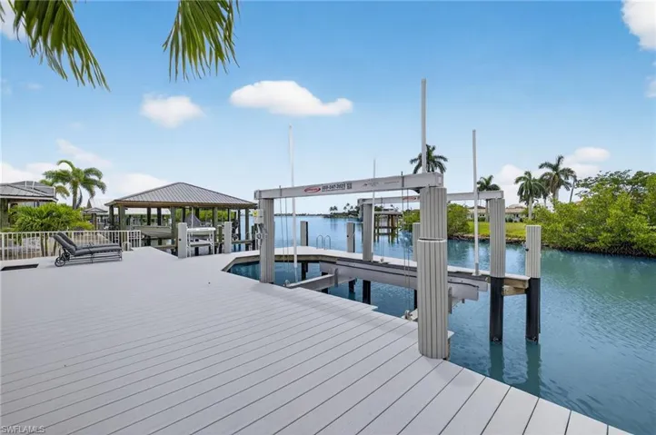 Dock with boat lift and a water view