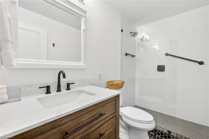 Full bath with vanity and a stall shower