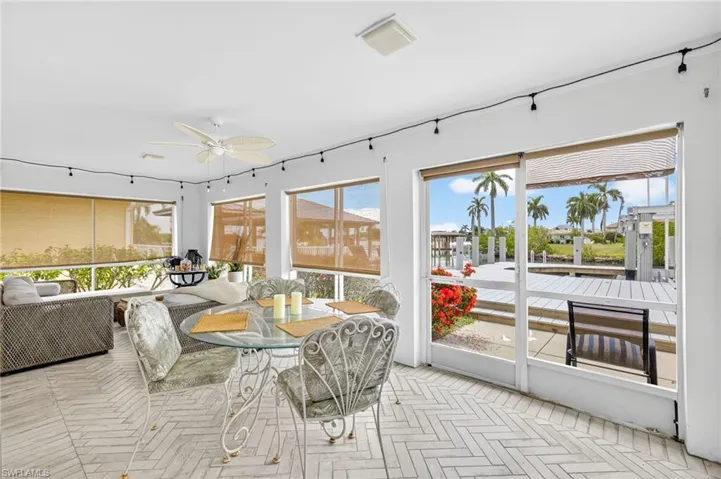 Sunroom featuring a ceiling fan