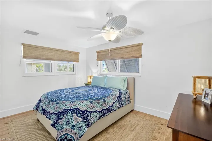 Bedroom with a ceiling fan and light wood-style floors