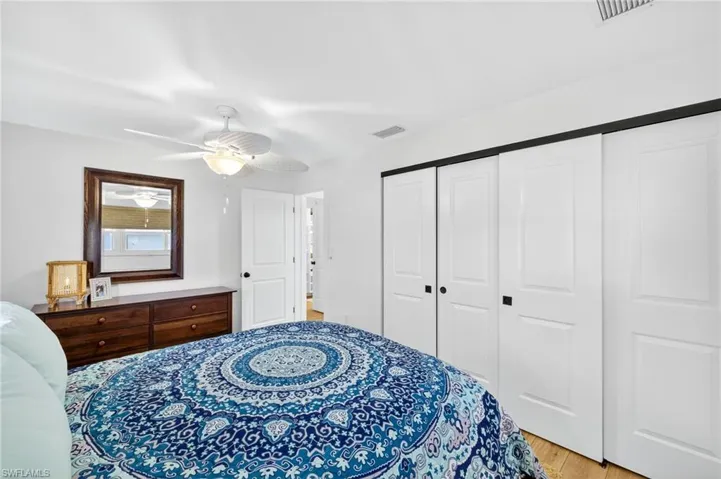 Bedroom featuring light wood-style floors, ceiling fan, and a closet