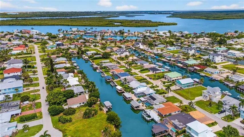 Aerial view of residential area featuring a large body of water