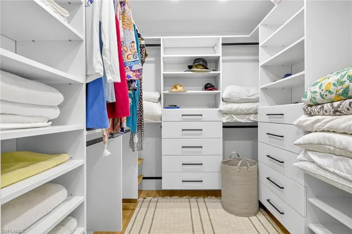 Walk in closet featuring light wood-type flooring