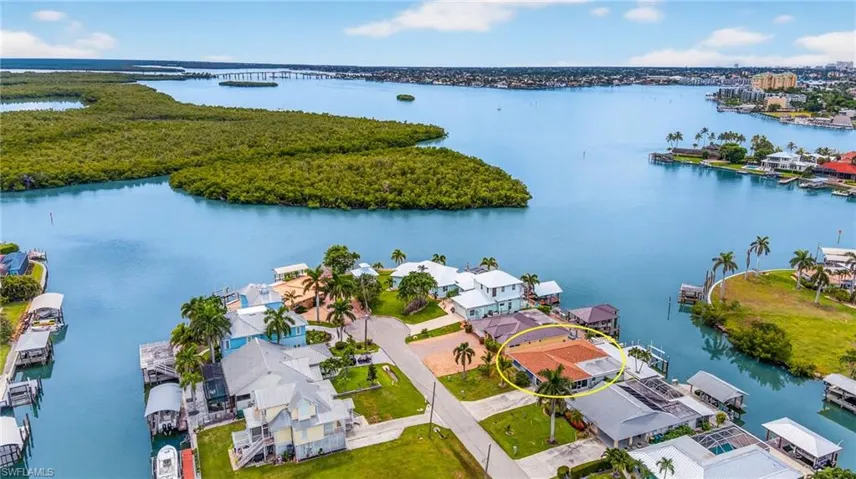 Aerial view of residential area featuring a nearby body of water