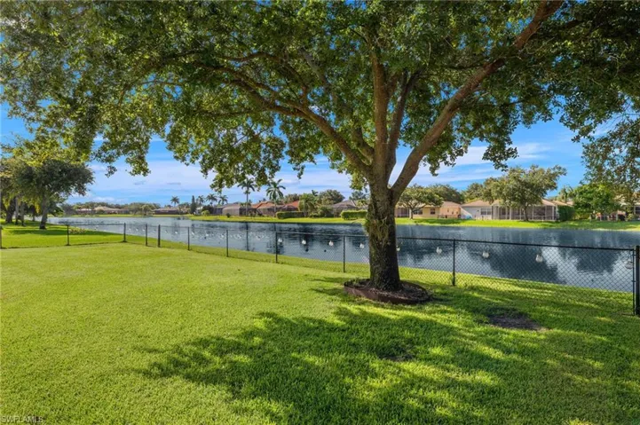 View of yard featuring a water view, fully fenced in yard.