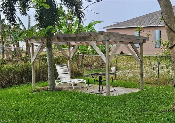 Yard with a pergola, a patio area, and a lawn