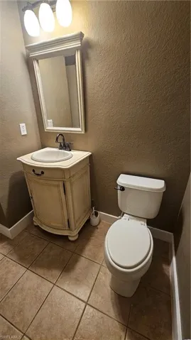 Bathroom with tile patterned flooring, vanity, and toilet