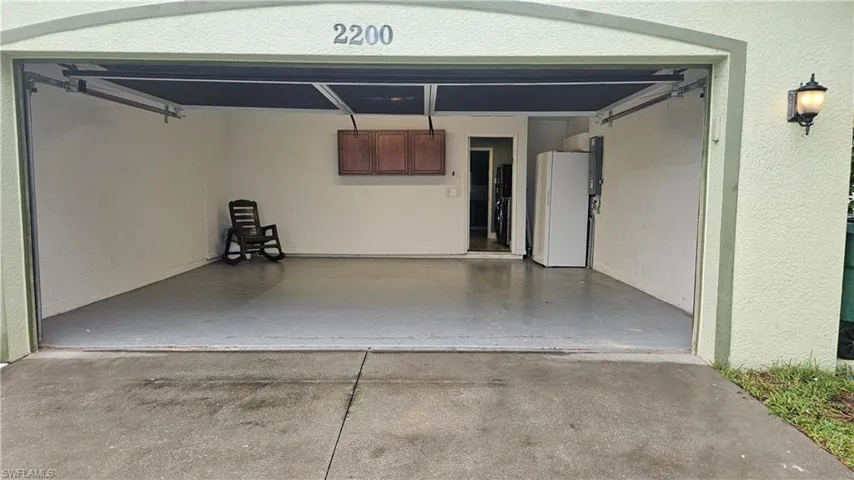 Garage with white refrigerator
