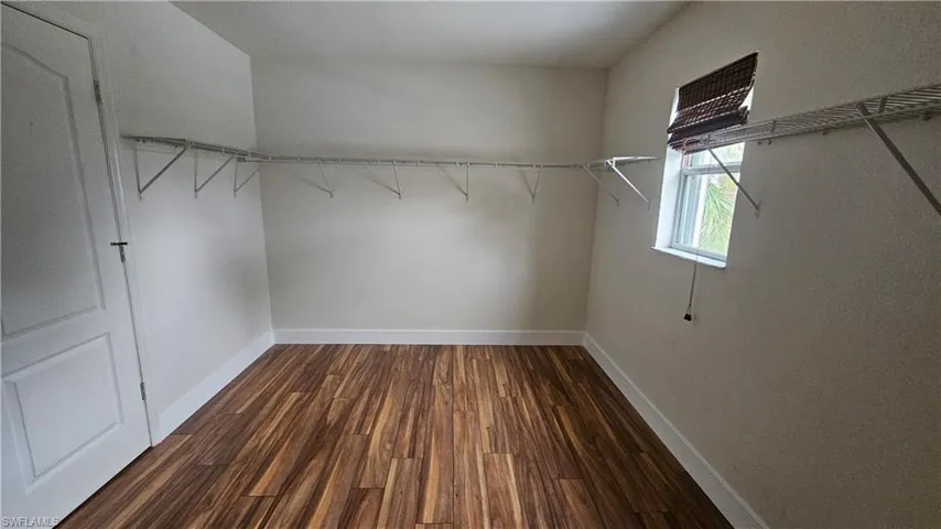 Walk in closet featuring dark hardwood / wood-style floors