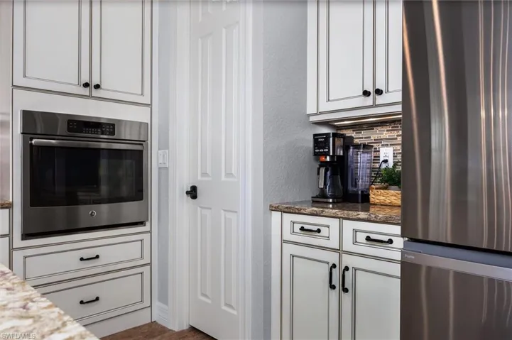 Built-in stainless steel oven with surrounding custom cabinetry