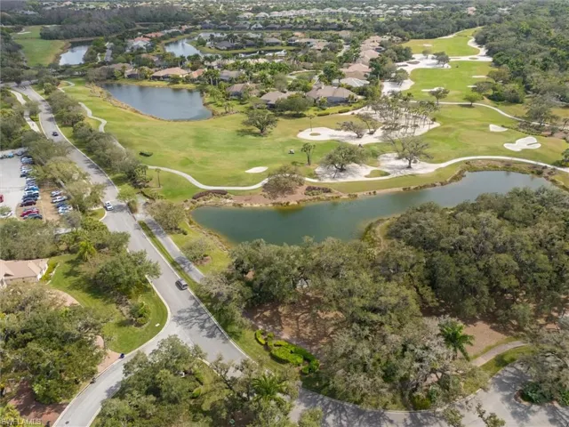 Expansive golf course setting featuring multiple greens and sand traps