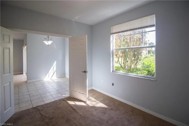 Empty room featuring light carpet