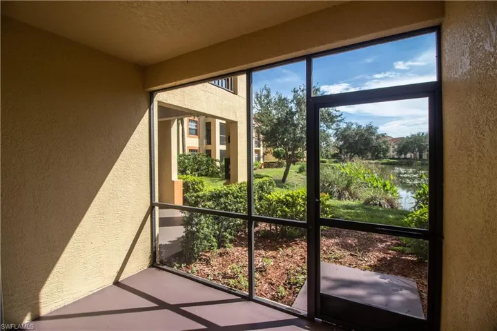 Unfurnished sunroom with a water view
