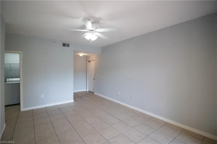 Spare room with light tile patterned floors, and ceiling fan