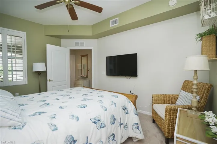 Bedroom featuring light carpet and ceiling fan