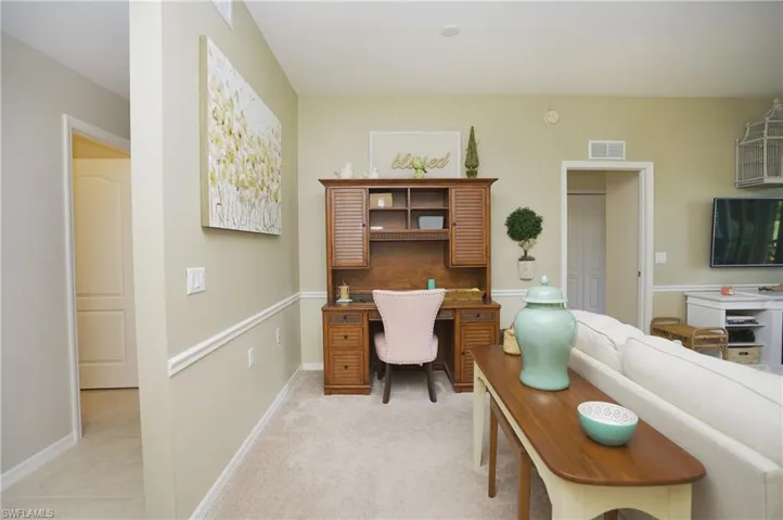 Office area featuring light carpet
