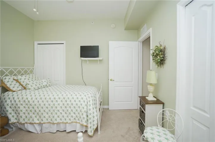 Bedroom with a closet and light carpet