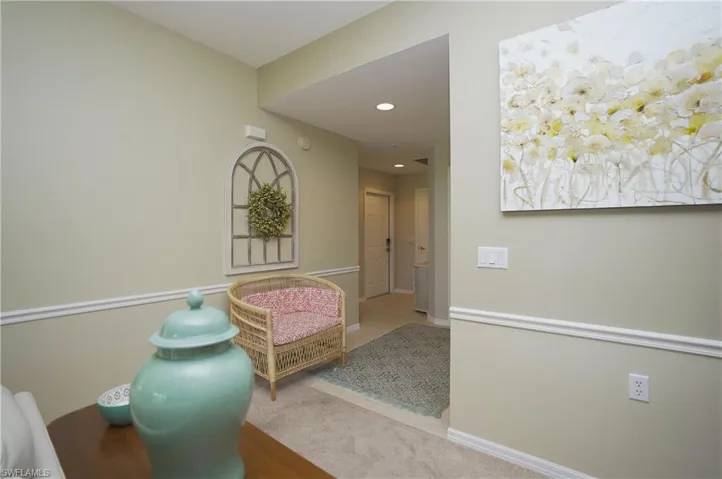 Corridor featuring light colored carpet