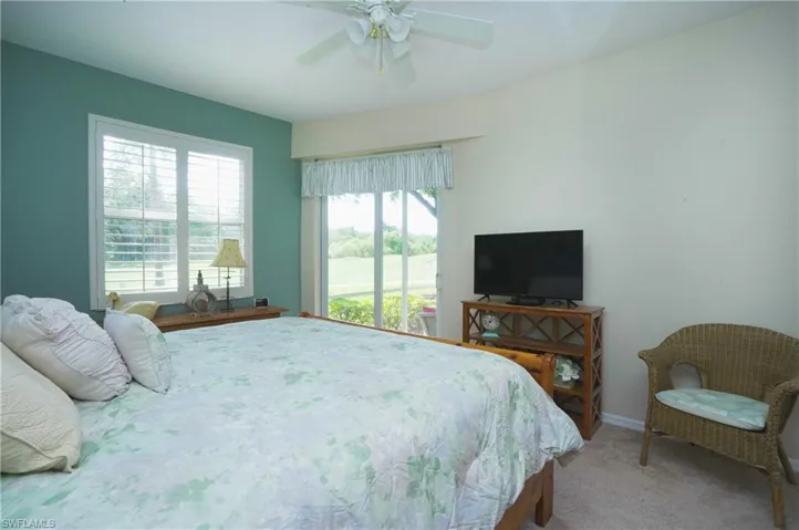 Bedroom featuring ceiling fan and carpet