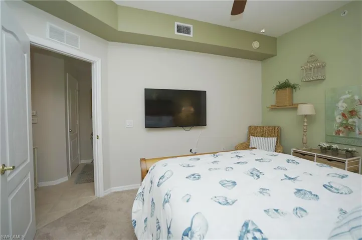 Bedroom with light colored carpet and ceiling fan