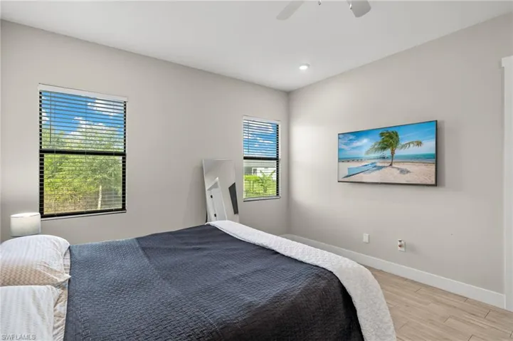 Bedroom with ceiling fan and light hardwood / wood-style flooring