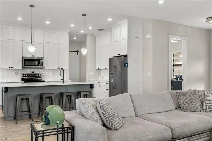 Living room featuring light hardwood / wood-style flooring and sink