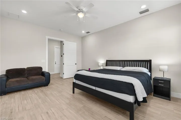 Bedroom with ceiling fan and light hardwood / wood-style flooring