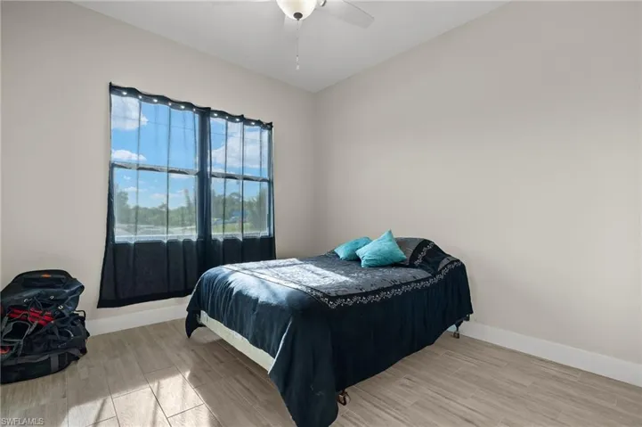 Bedroom with wood-type flooring and ceiling fan