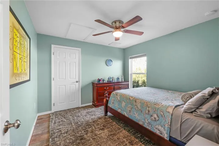 Bedroom featuring dark hardwood / wood-style floors and ceiling fan
