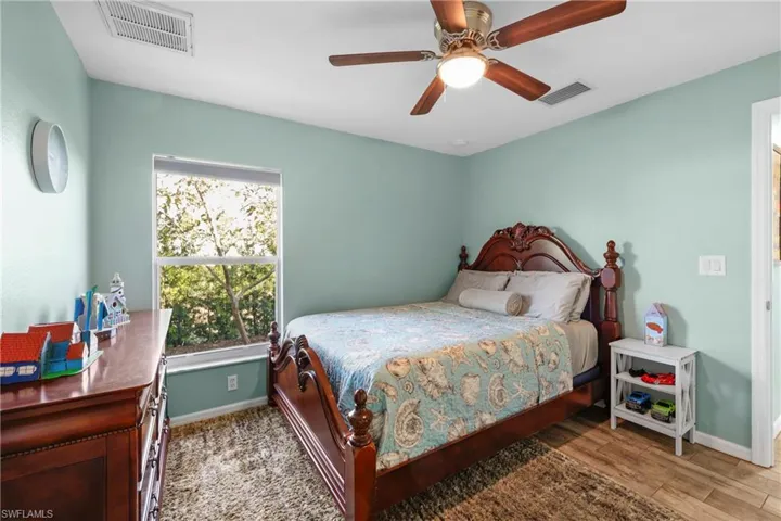 Bedroom featuring wood-type flooring and ceiling fan