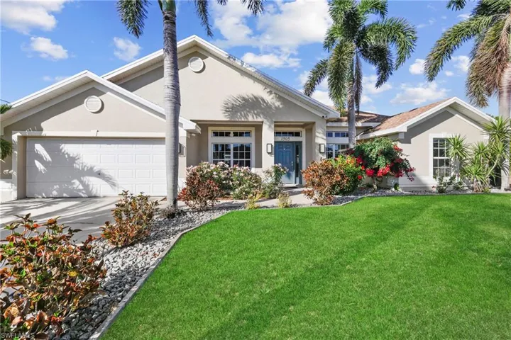 View of front of home featuring a garage and a front lawn