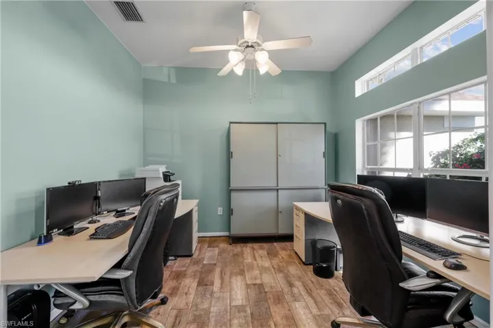 Office space with ceiling fan and light hardwood / wood-style floors