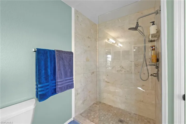 Bathroom featuring toilet and tiled shower