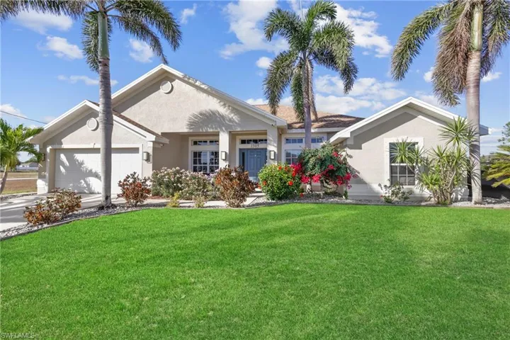 View of front of property featuring a garage and a front yard