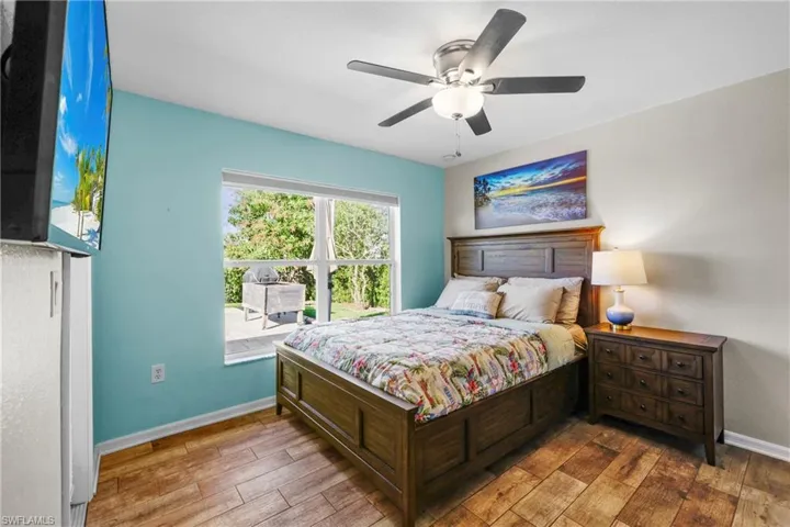Bedroom with ceiling fan and hardwood / wood-style floors