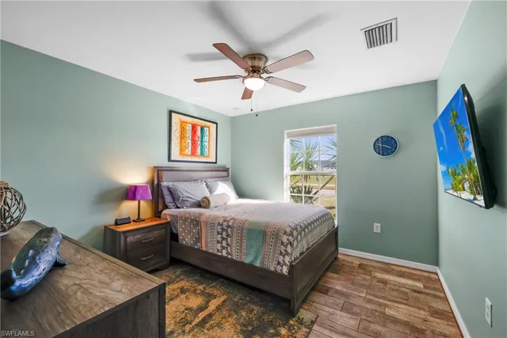 Bedroom featuring dark wood-type flooring and ceiling fan