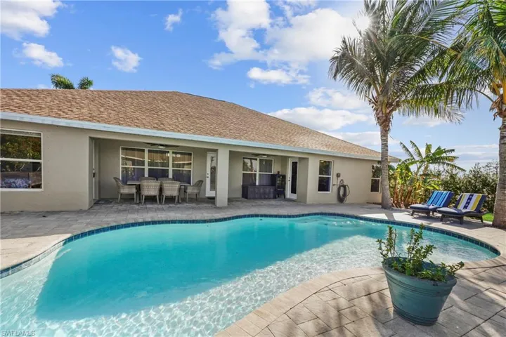 View of swimming pool featuring a patio area and ceiling fan