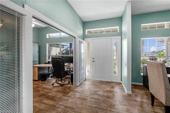 Entryway featuring a high ceiling and hardwood / wood-style floors