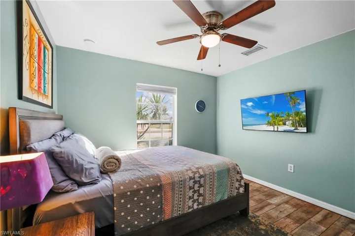 Bedroom with hardwood / wood-style flooring and ceiling fan