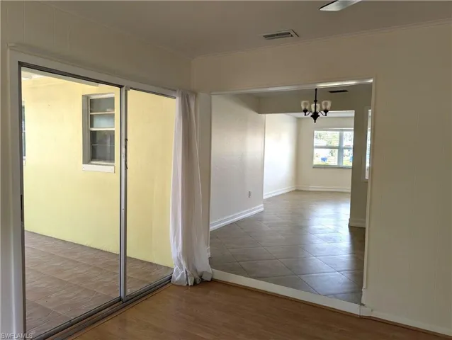 View of back to front thru the dining room and slider doors to the screened lanai