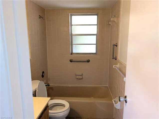 Guest Bathroom featuring toilet, bathtub / shower combination, and vanity