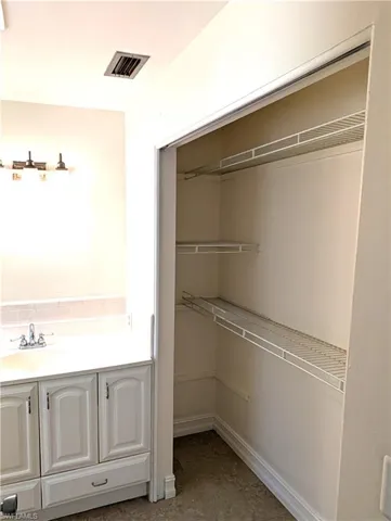 Primary bath Closet featuring a vanity sink