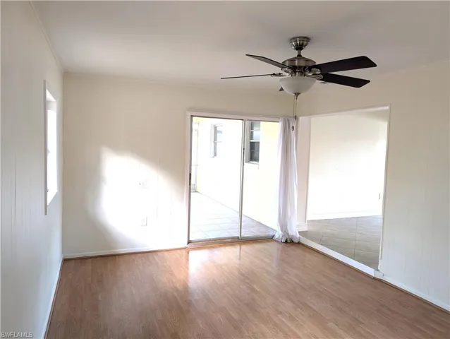 Family room with wood finished floors, ceiling fan, and baseboards