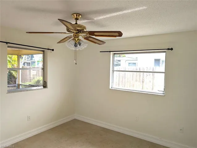 3rd bedroom featuring  ceiling fan, baseboards, and windows of natural light