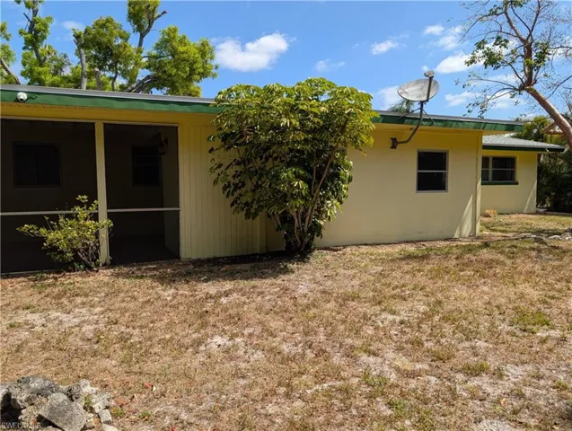 Rear view of house featuring a sunroom