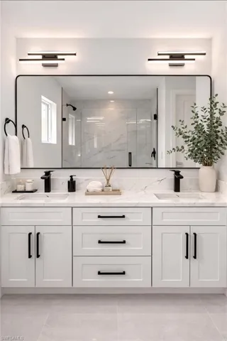 Full bathroom with double vanity and a shower stall