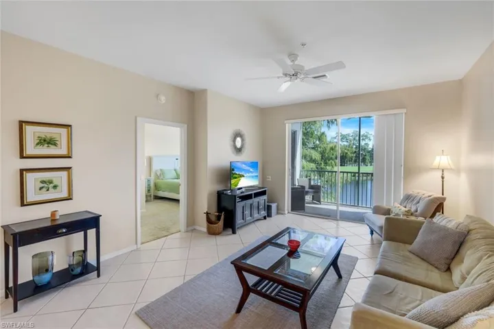 Living area with light tile patterned flooring and a ceiling fan